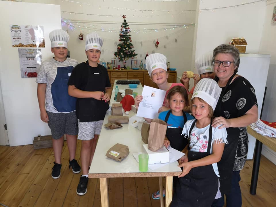 A focused young baker working on their creation at Pikanini Chefs