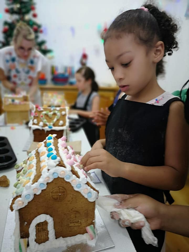 A little chef decorating a treat