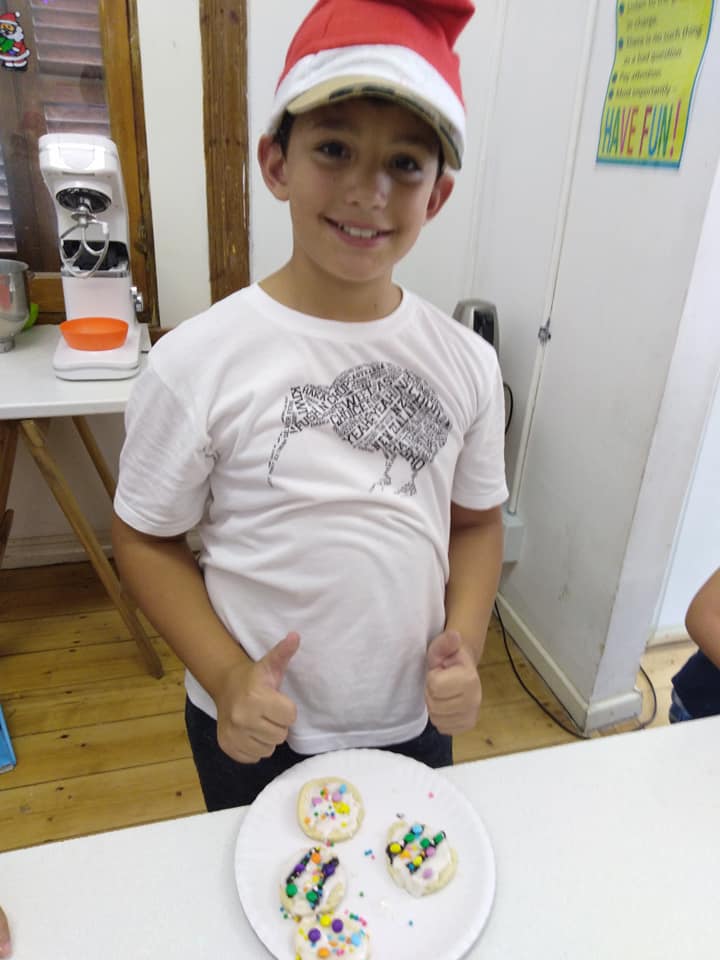 A child concentrating on their bake