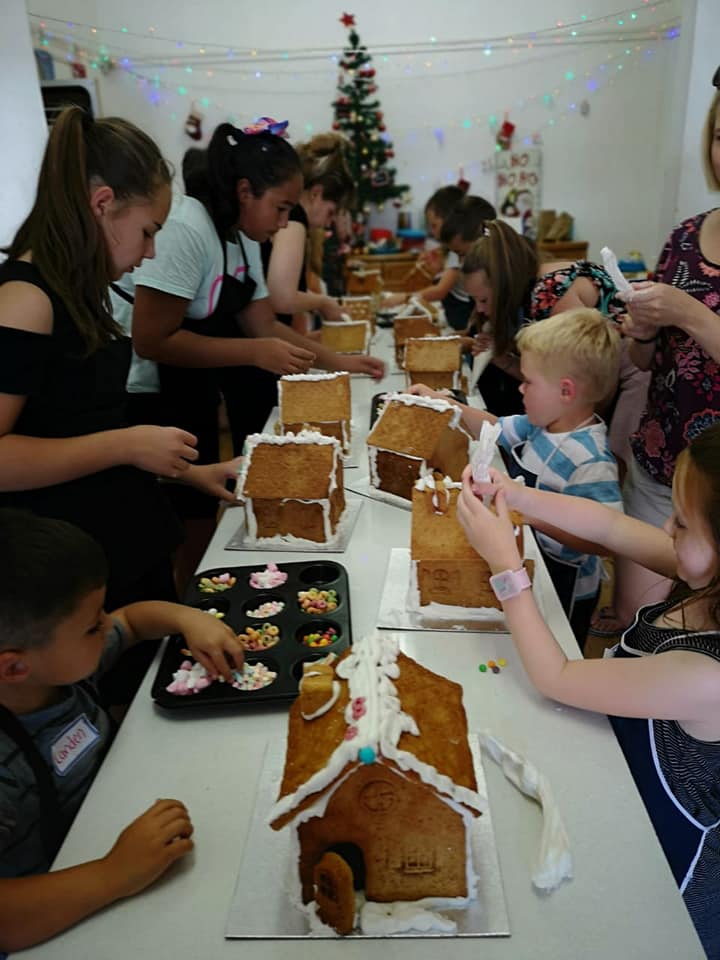 A young baker concentrating on their treat